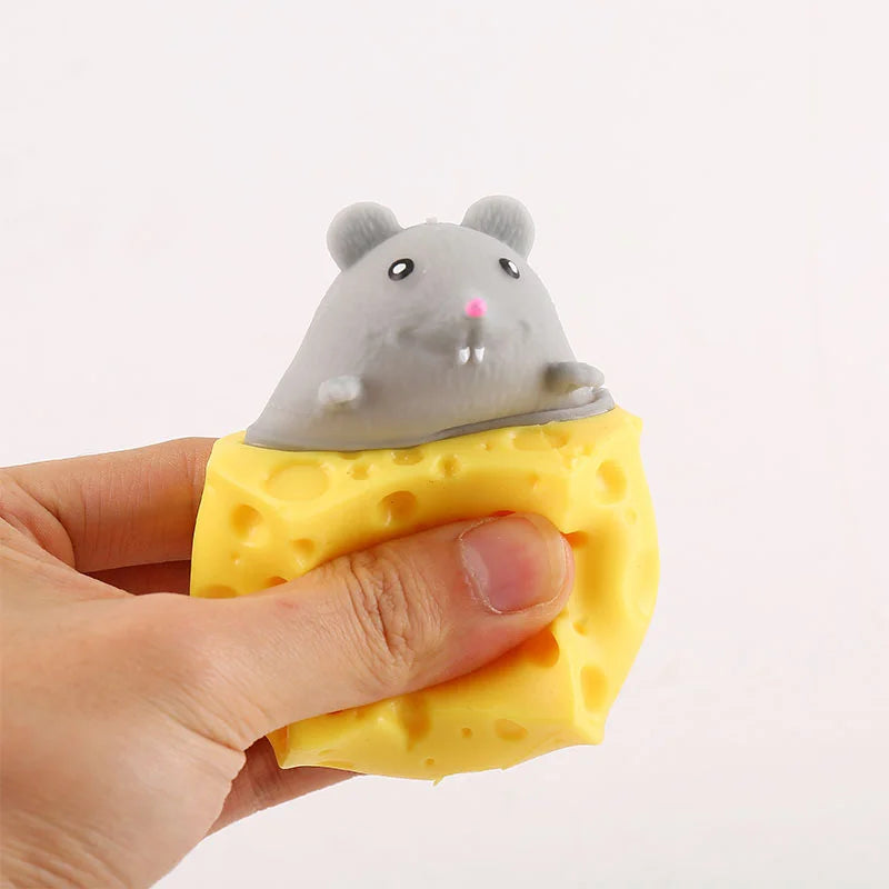 Gray mouse face on a triangle yellow cheese squishy toy with round hole details.