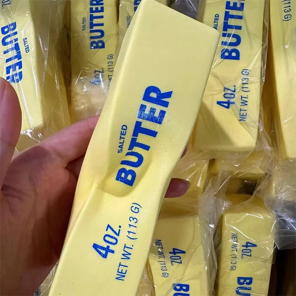 Yellow butter-stick squishy toy held sideways, blue salted BUTTER and 4oz 113g