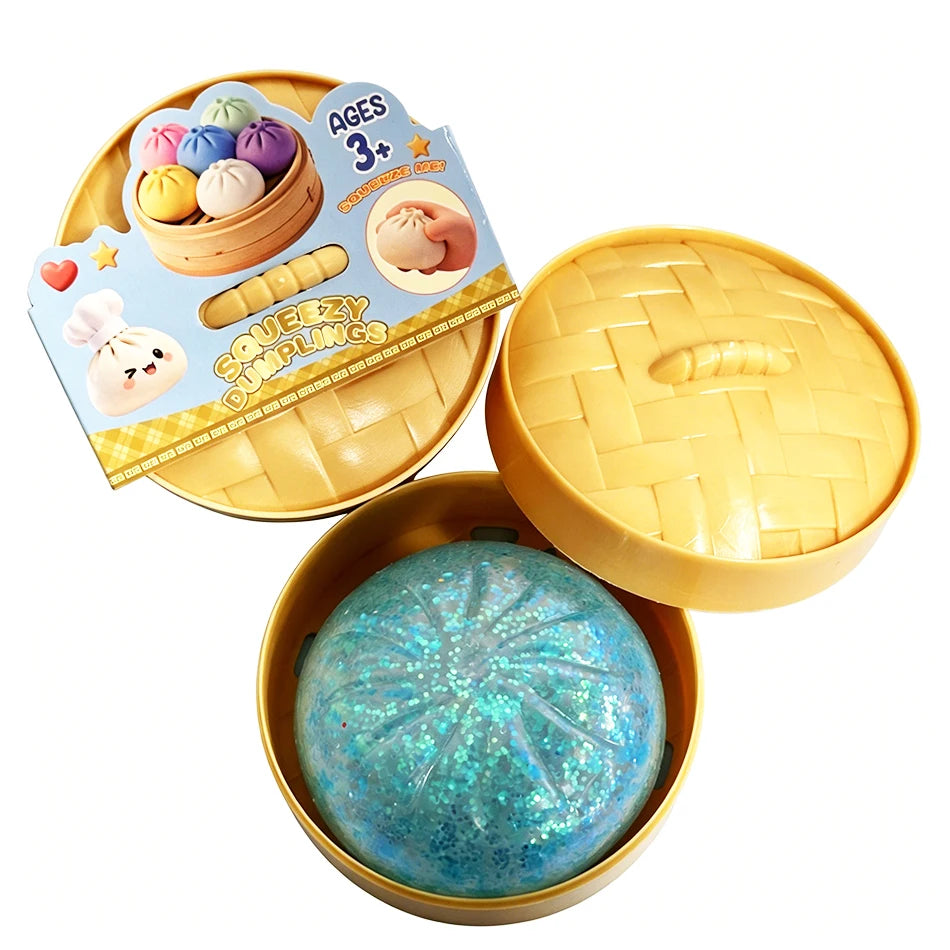 Dumpling squishy fidget toy with teal glittery ball in yellow tray, lid open