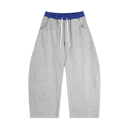 Heather gray barrel sweatpants with plaid blue elastic waistband and drawstring